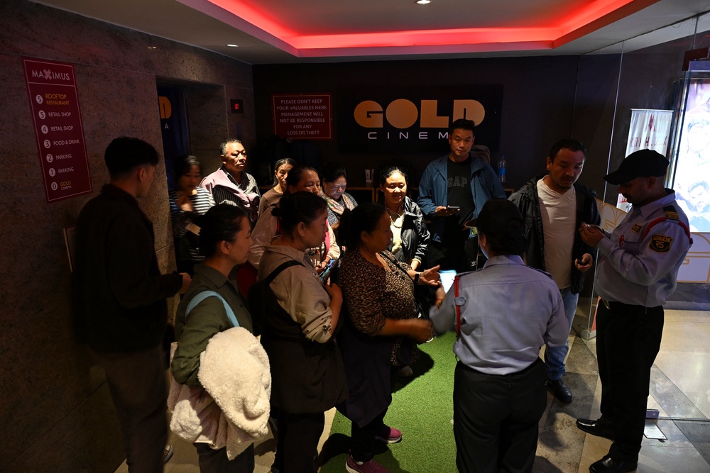 People gather at a movie theatre to watch Four Rivers Six Ranges, a historical drama about resistance fighters who helped the Dalai Lama escape Tibet in 1959, in Dharamshala, India, Thursday, oct. 1, 2026. (AP Photo/Tenzin Lekmon) (Copyright 2026 The Associated Press. All rights reserved.)