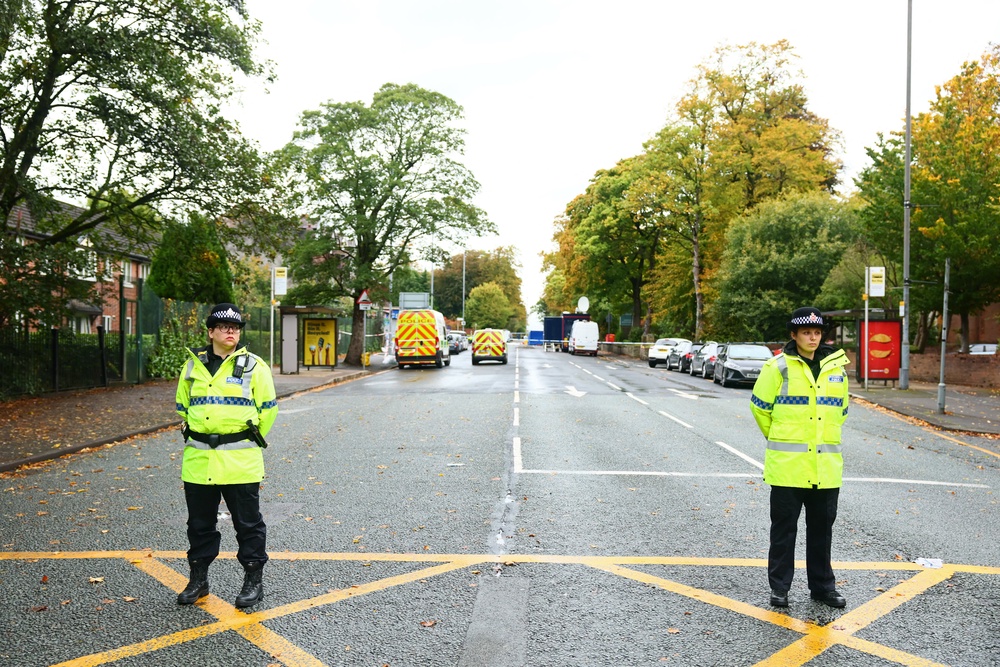 Police officers stand by a cordon on the main road outside Heaton Park Hebrew Congregation synagogue in Crumpsall, north Manchester, on October 3, 2025, following an attack at the synagogue (AFP/Getty)
