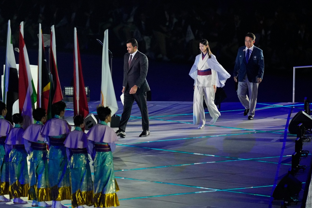 Sheikh Joaan bin Hamad Al Thani, centre, left, president of the Olympic Council of Asia, and Aichi Gov. Hideaki Ohmura, right, the president of the Aichi-Nagoya Asian Games Organizing Committee, get on stage during the opening ceremony for the Asian Games in Nagoya, Japan, Saturday, 19 September 2026 (AP)