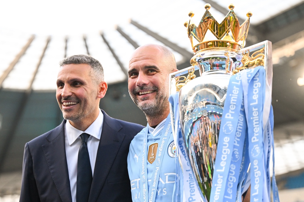Khaldoon Al Mubarak, Chairman of Manchester City, and Pep Guardiola celebrate with the Premier League trophy (Getty)