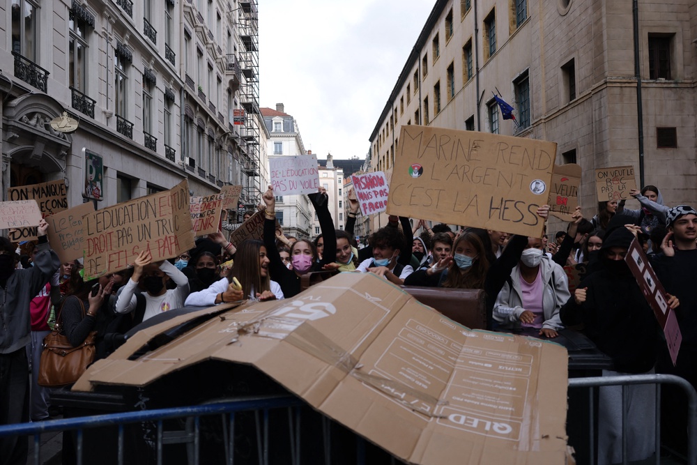 Students in Lyon hold placards reading ‘Education is a right, not something for rich kids’ (AFP/Getty)