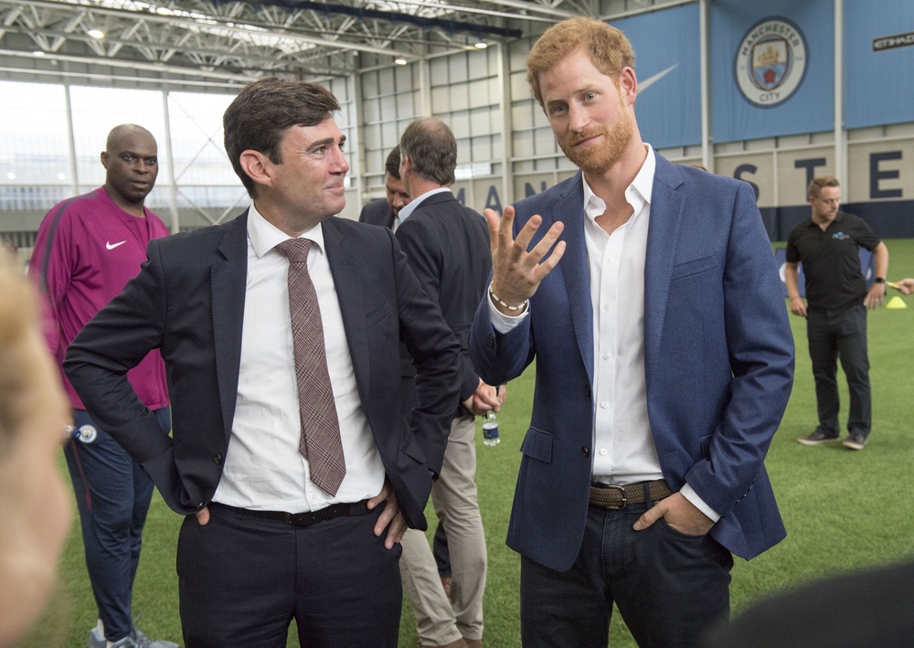 The then Manchester mayor joins Prince Harry at Manchester City's training ground (PA)