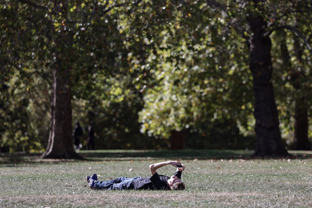 A man rests in a park in central London on October 1, 2026, as temperatures reached 20C following a record warm summer (Brook Mitchell / AFP via Getty Images)