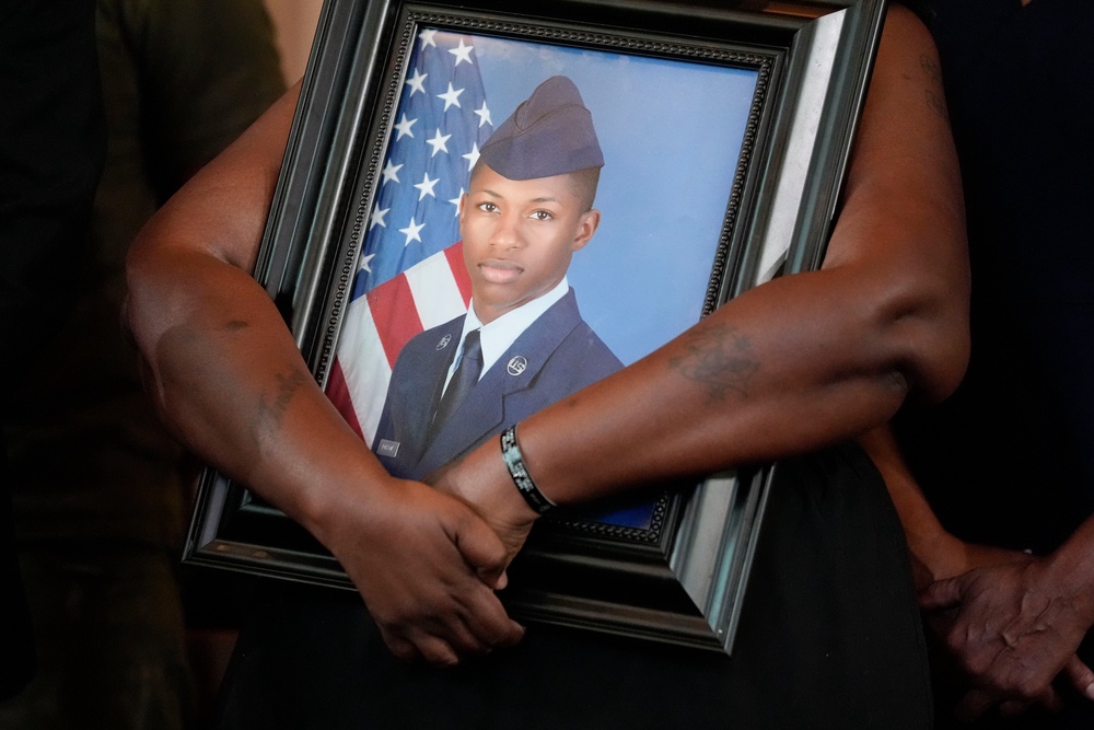 Chantemekki Fortson, mother of slain U.S. Air Force senior airman Roger Fortson, holds a photo of her son during a news conference with attorney Ben Crump on June 3, 2024, in Atlanta (AP Photo/Brynn Anderson)