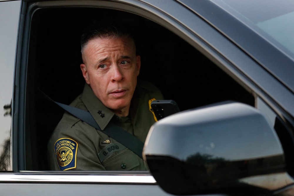 Johnson made the allegedly defamatory comments during a ride-along with then-Border Patrol ‘commander-at-large’ Gregory Bovino, who oversaw a surge of immigration officers into Democratic cities, sparking a series of violent confrontations (AFP/Getty)