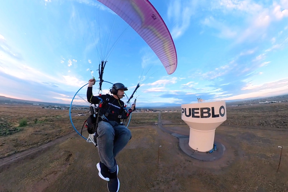 In this image taken from video provided by Jacob Hutzler shows Hutzler flies his paramotor to work as an air traffic controller in Pueblo, Colo., on Aug. 13, 2026. (Jacob Hutzler via AP) (Jacob Hutzler)