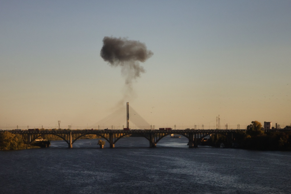 Smoke rises over a bridge spanning the Dnieper River following a drone attack in Kyiv on 2 October 2026, amid the Russian invasion of Ukraine (AFP/Getty)