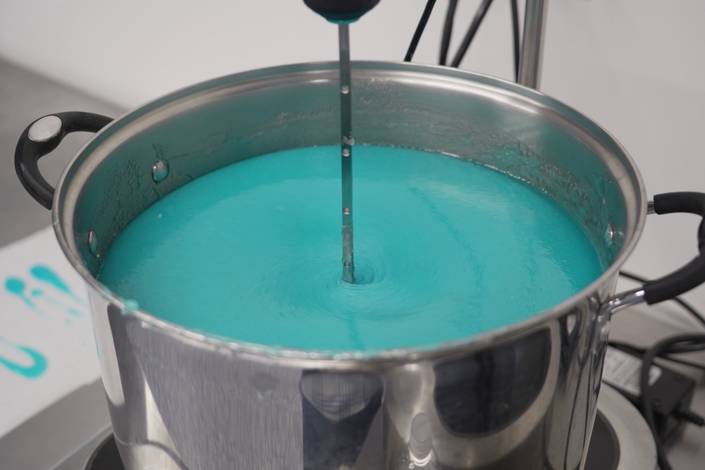 A mixer stirs a batch of blueberry lemonade gummies in a heated pot at the Deutermann Farms kitchen in Clayton, N.C., on Wednesday, Sept. 23, 2026. (AP Photo/Allen G. Breed) (Copyright 2026 The Associated Press. All rights reserved)