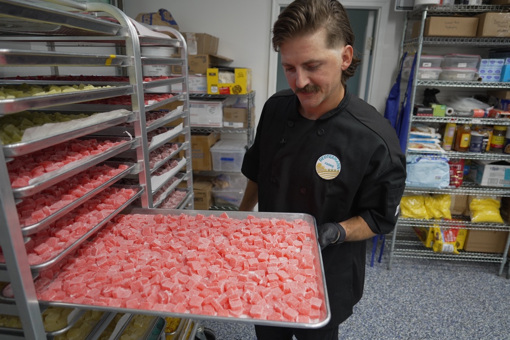 Nicholas Hohns shows off a tray of strawberry-lemon CBD gummies at his Deutermann Farms kitchen in Clayton, N.C., on Wednesday, Sept. 23, 2026. (AP Photo/Allen G. Breed) (Copyright 2026 The Associated Press. All rights reserved)