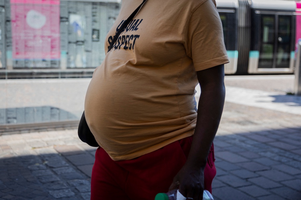 A pregnant woman walks through the French city of Grenoble during a heatwave in early July (AFP/Getty)