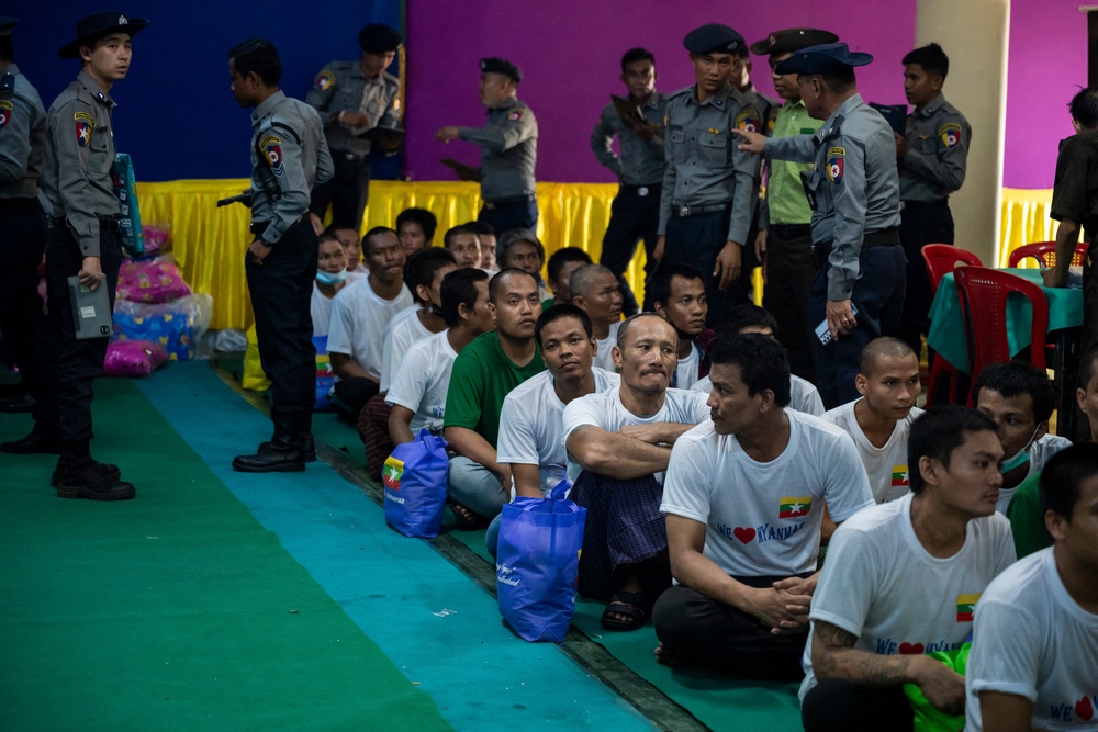 Myanmar migrants repatriated from Malaysia sit together at a temple during their official welcoming process (AFP/Getty)