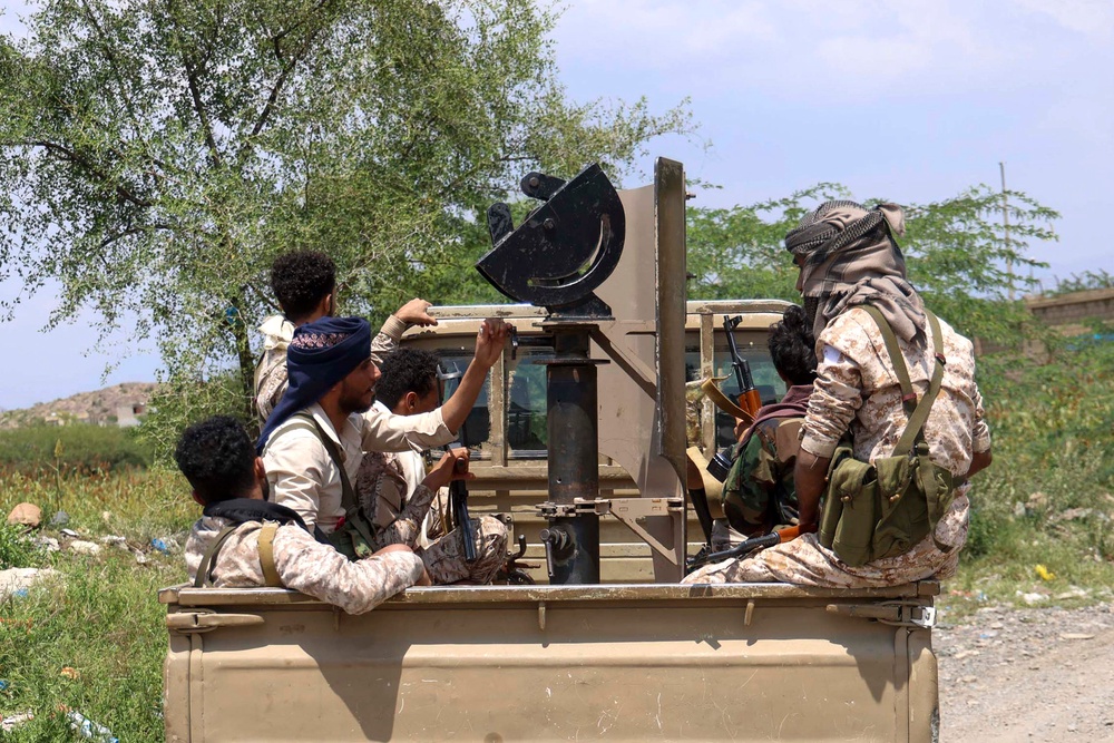 Saudi-backed Yemeni government forces ride in the back of a military truck at the Jabal Han front west of the city of Taiz following fierce battles earlier in the day as Yemen's Houthis reportedly attempted to seize control of the main route between the inland city of Taiz and the coastal city of Aden, on October 3, 2026. (AFP/Getty)
