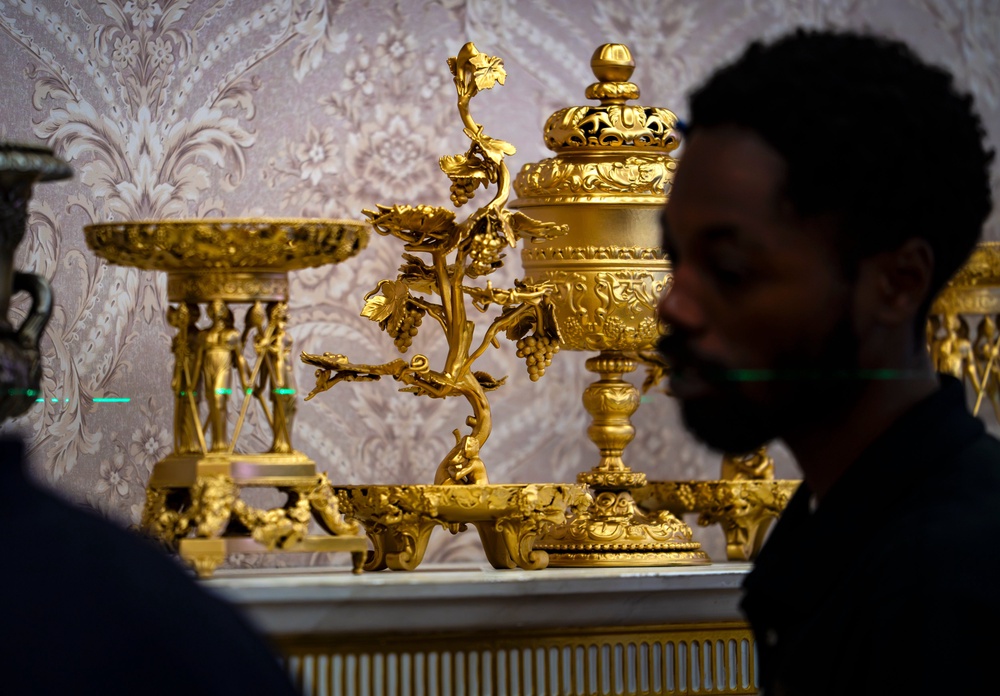 A replica of President Donald Trump's Oval Office is updated to the current decor by workers at 