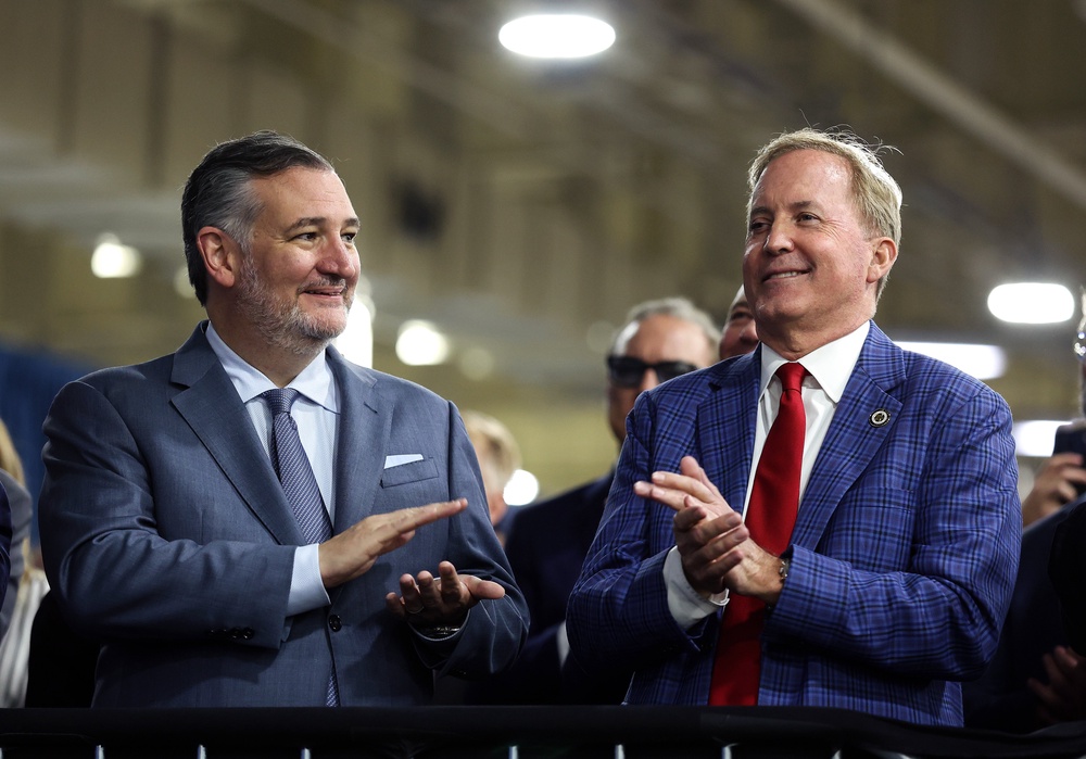 Sen. Ted Cruz (R-Texas) (L) and Republican Senate candidate Texas Attorney General Ken Paxton (R) watch as U.S. President Donald Trump speaks during a visit to the Peterbilt Motors truck plant on October 01, 2026, in Denton, Texas. (Getty)