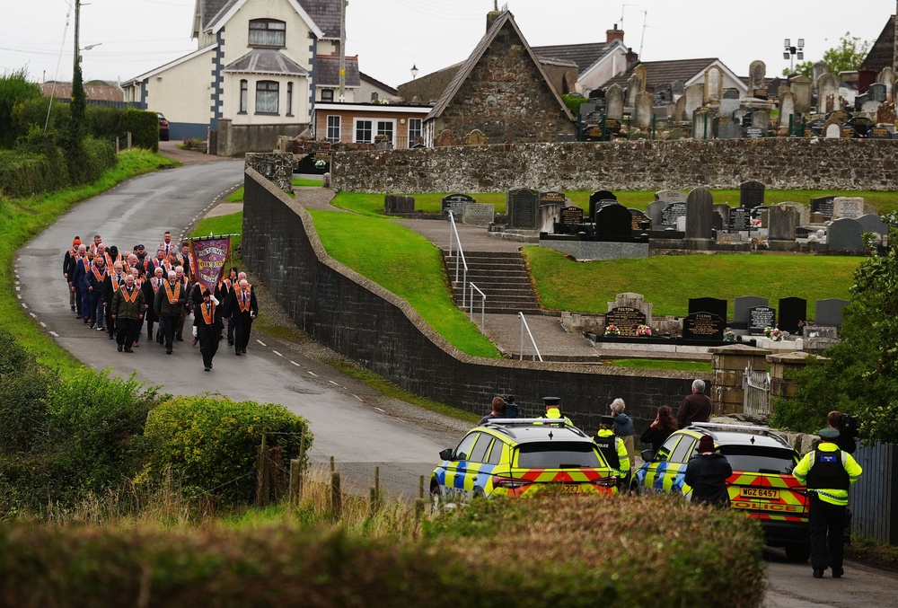 Orangemen make their way from Drumcree Church as police form a barricade to prevent them entering the Garvaghy Road (Brian Lawless/PA) (PA Wire)