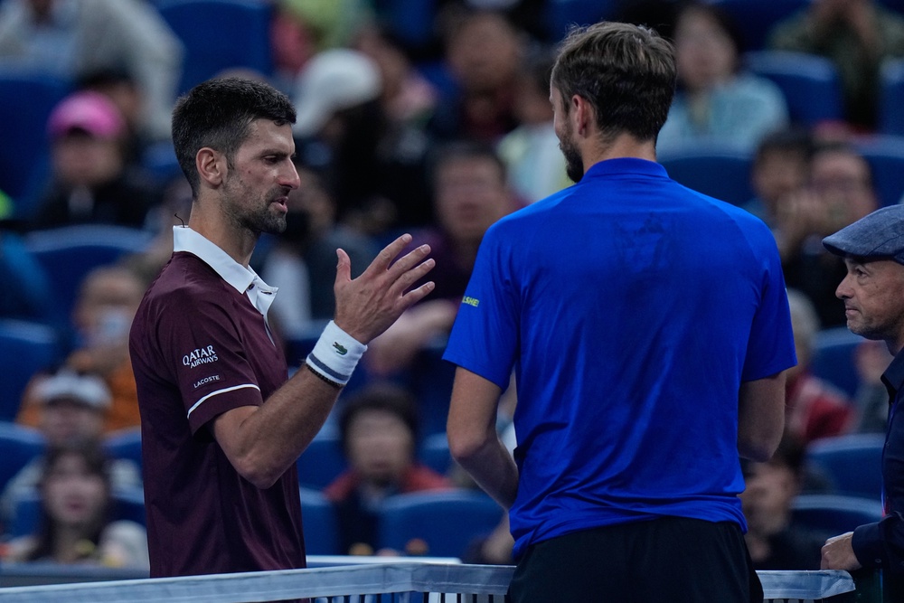 Novak Djokovic, left, consoles Medvedev after his disqualification (Andy Wong/AP) (AP)
