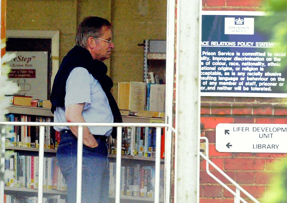 Disgraced Tory peer Lord Archer walks through the library at Hollesley Bay Prison, ahead of his release (PA) (PA Archive)