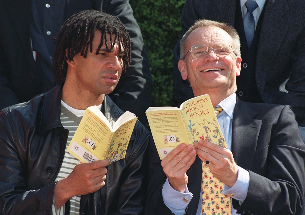 Former football player and coach Ruud Gullit and Lord Archer read ‘The Children's Book of Books’ in London (PA)