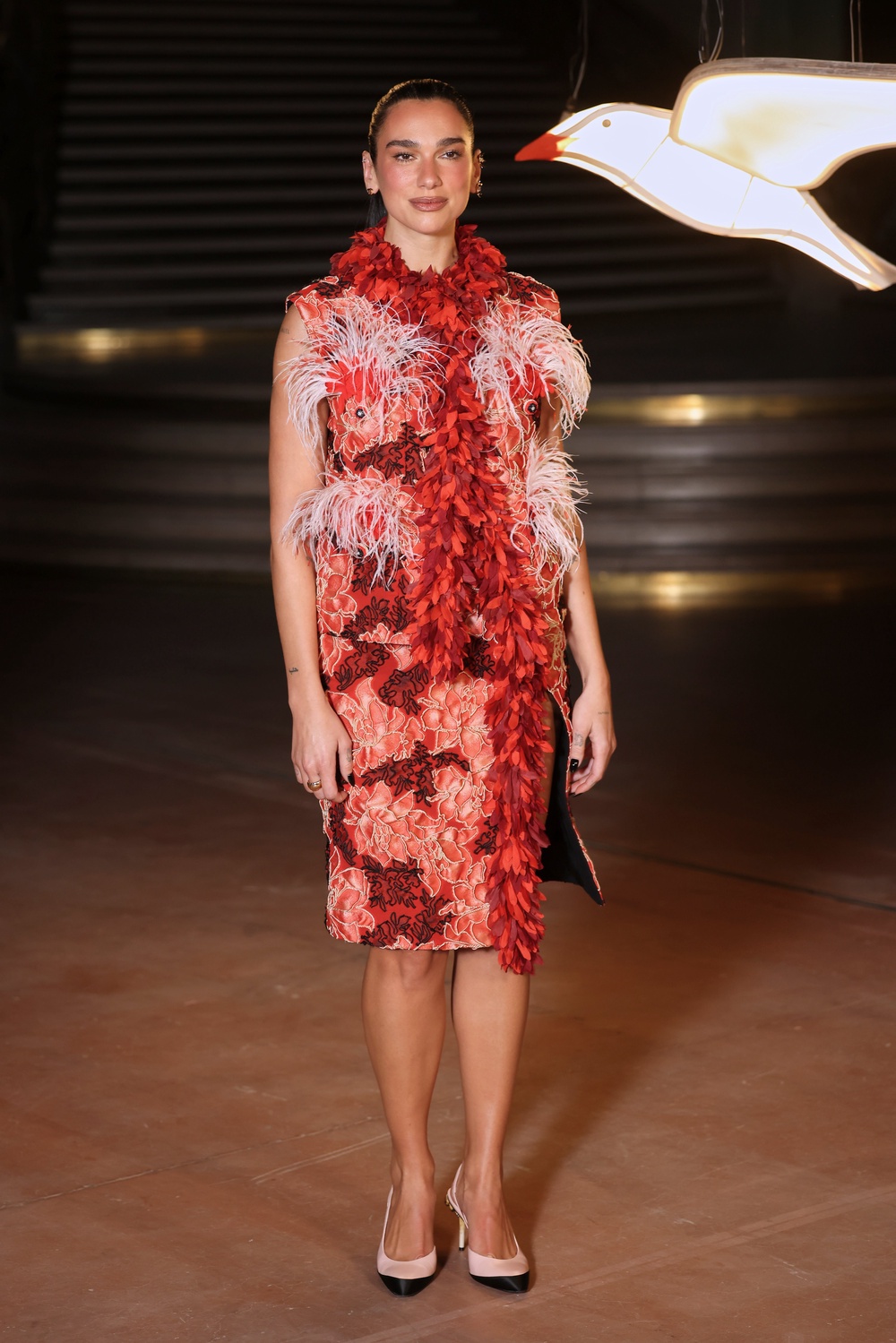 Dua Lipa in a feathered dress from Chanel’s Cruise 2026/27 collection (Thomas Padilla/AP) (AP)