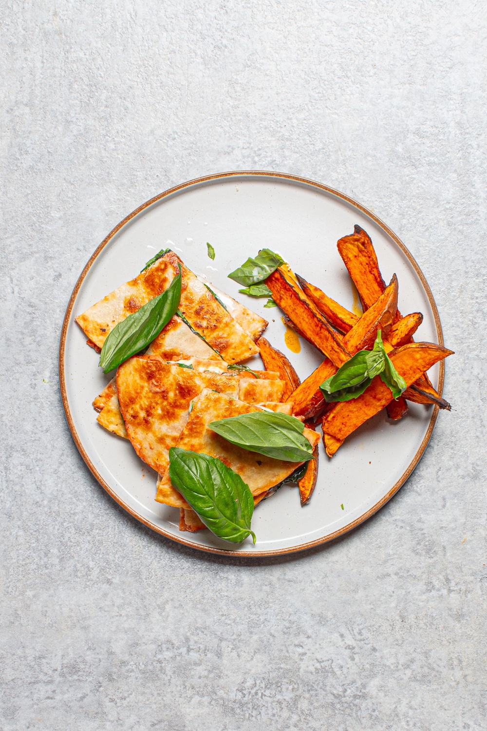 Crisp, cheesy pizzadillas with smoky sweet potato wedges and fresh basil (Sorted Food)