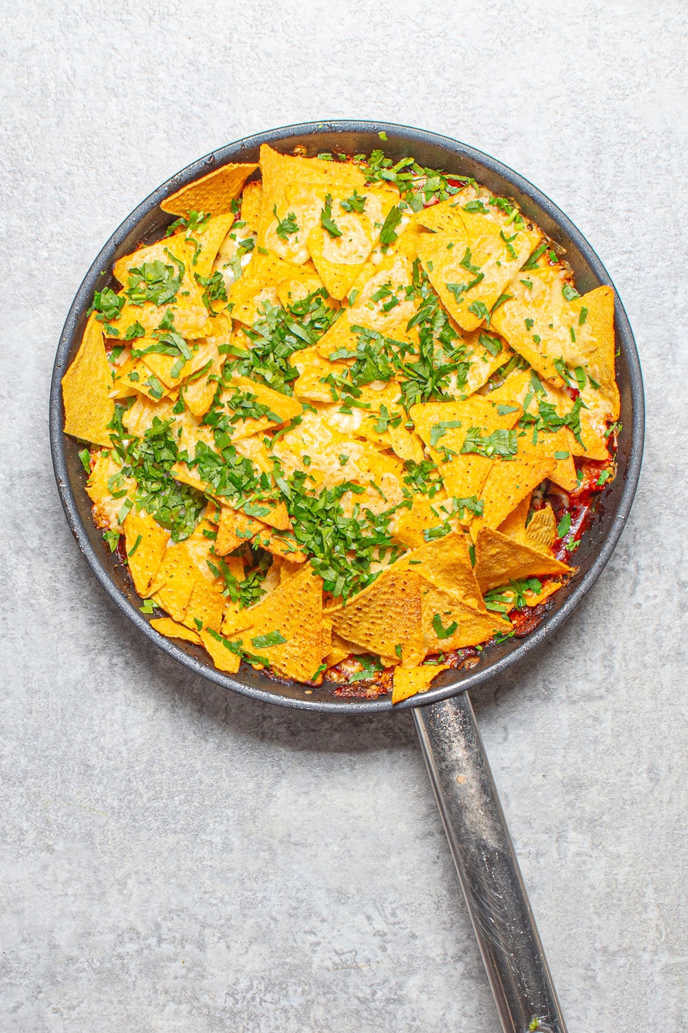A bubbling chicken and bean bake topped with tortilla chips, melted cheese and coriander (Sorted Food)