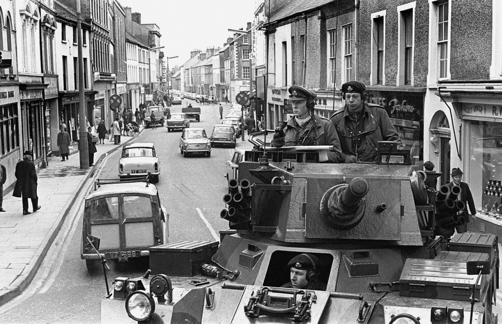 A British armoured car of the 17/21st Lancers moves through Strabane, Co Tyrone in April 1969 (PA)