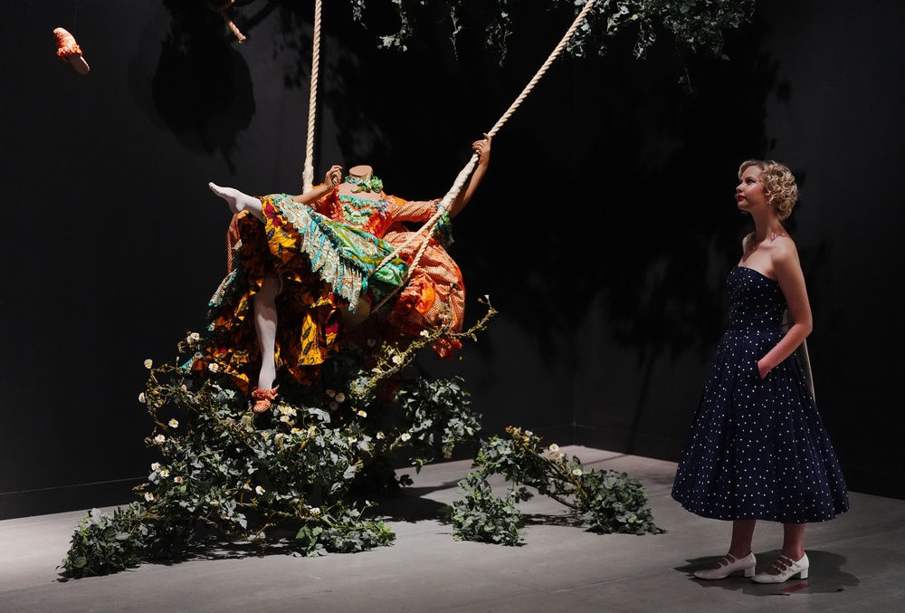 A visitor views The Swing (after Fragonard) by Yinka Shonibare, part of The 90s: Art and Fashion exhibition (Jonathan Brady/PA) (PA Wire)