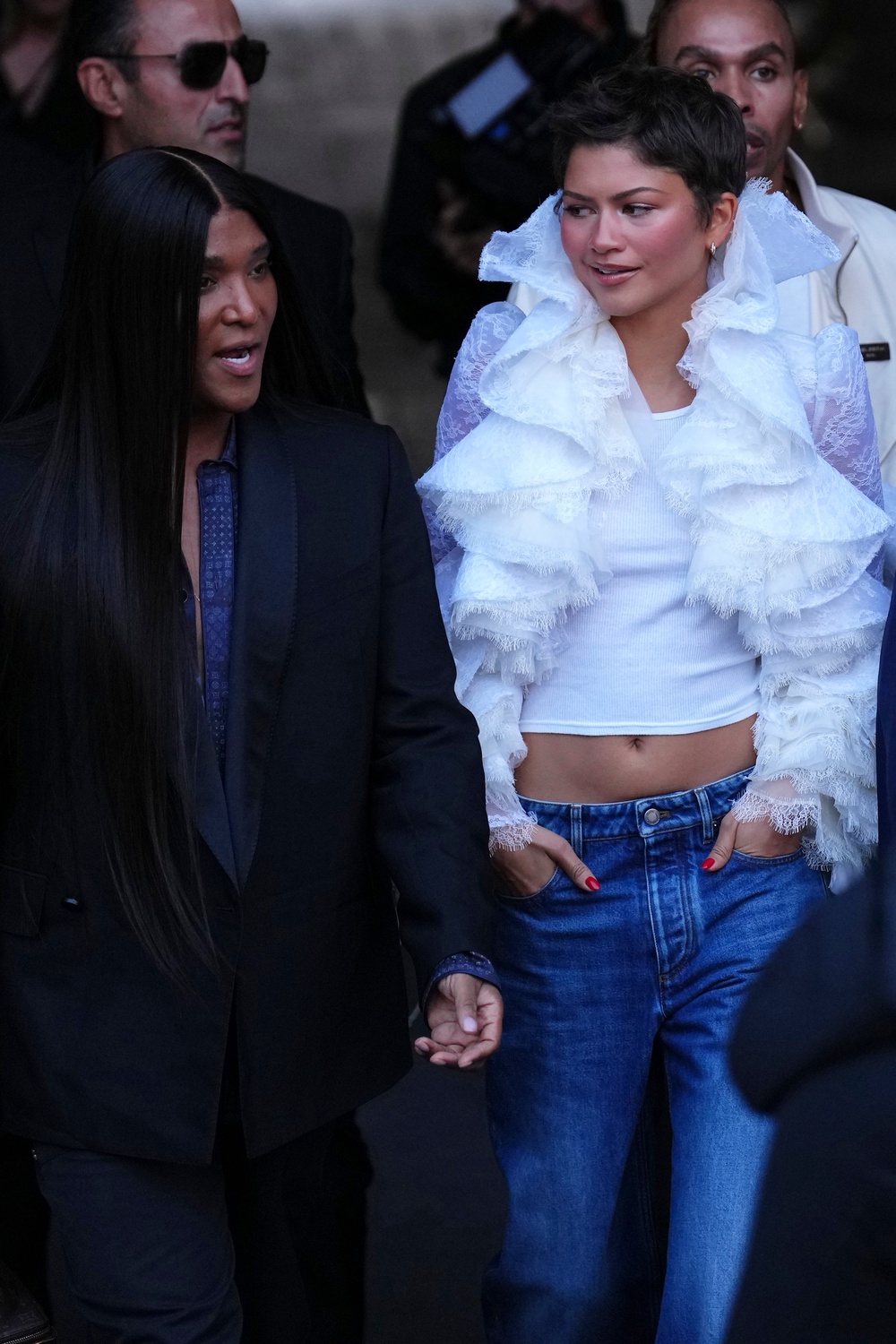 Zendaya in low rise jeans and a ruffle lace jacket with her stylist Law Roach, left, at the Louis Vuitton SS27 show (Aurelien Morissard/AP) (AP)