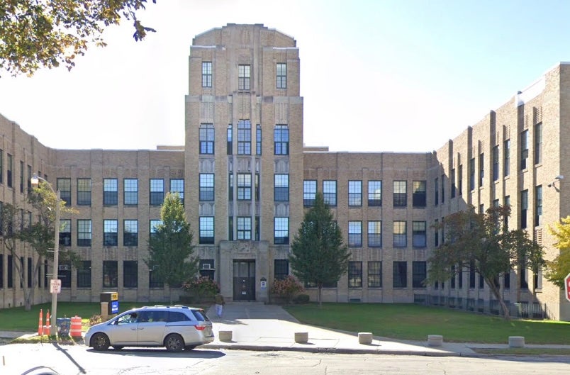 Students at Rufus King International High School told a school resource officer that Jones was 'using profane language, racial slurs, sexually derogatory statements and organizing students by race and gender in class,' according to a criminal complaint (Google Earth)