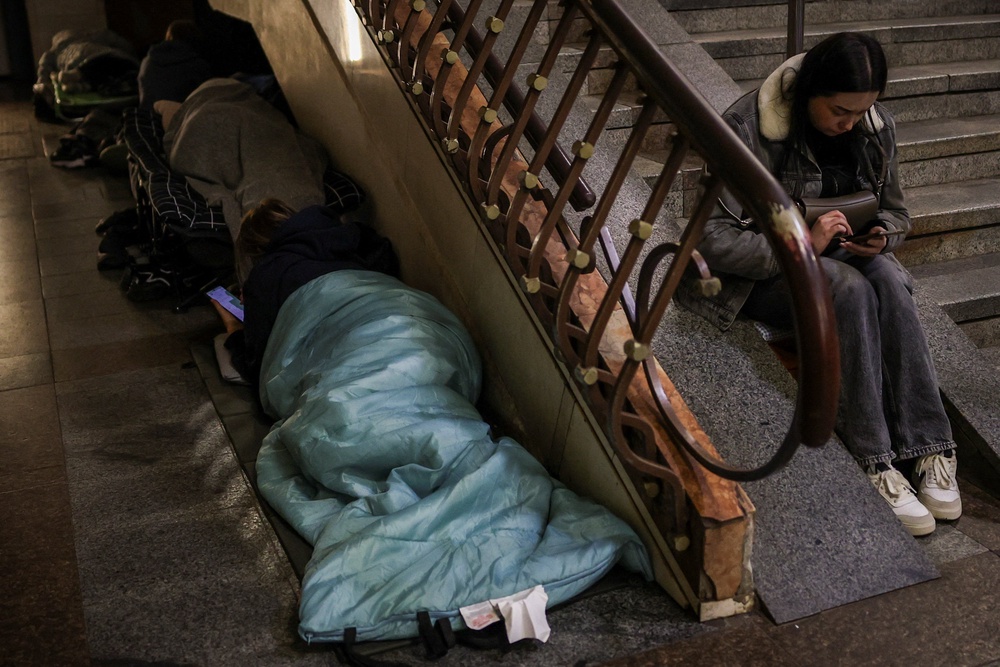 People take shelter inside a metro station during a Russian missile strike in Kyiv (Reuters)