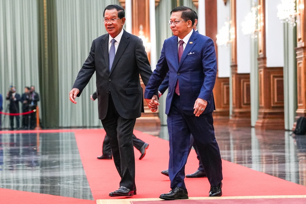 Cambodia's Senate chief Hun Sen holds hands with Min Aung Hlaing during a welcoming ceremony in Phnom Penh on 11 September 2026 (Reuters)