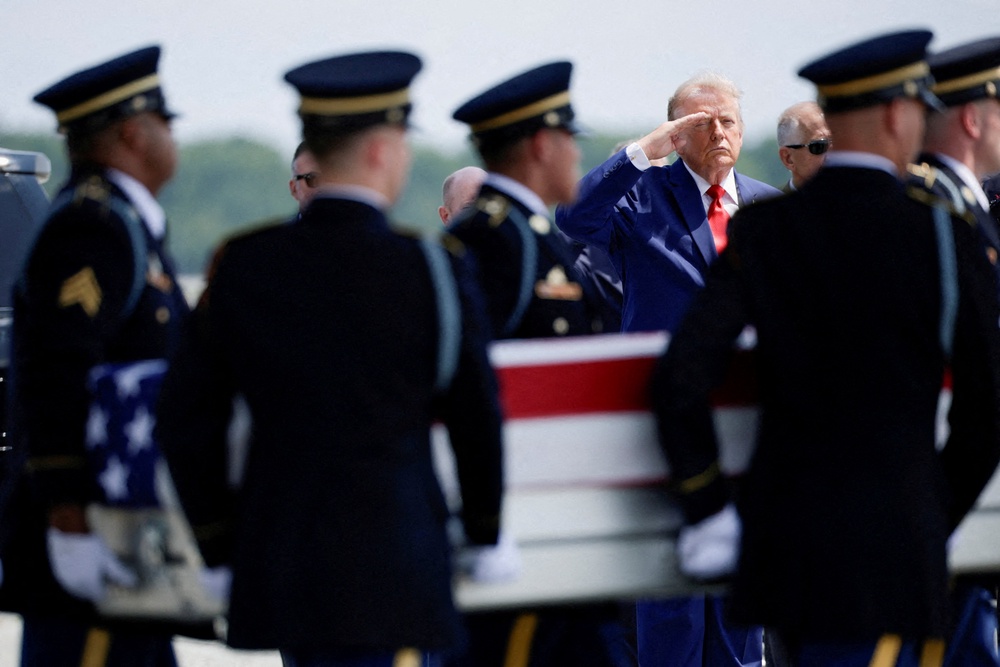 President Donald Trump salutes as members of the military carry the transfer case of U.S. Army Sgt. Angel S. Rampersad of the 1st Battalion, 57th Air Defense Artillery Regiment, 52nd Air Defense Artillery Brigade, 10th Army Air Missile Defense Command, who was killed during an attack at Muwaffaq Salti Air Base in Jordan (Reuters)