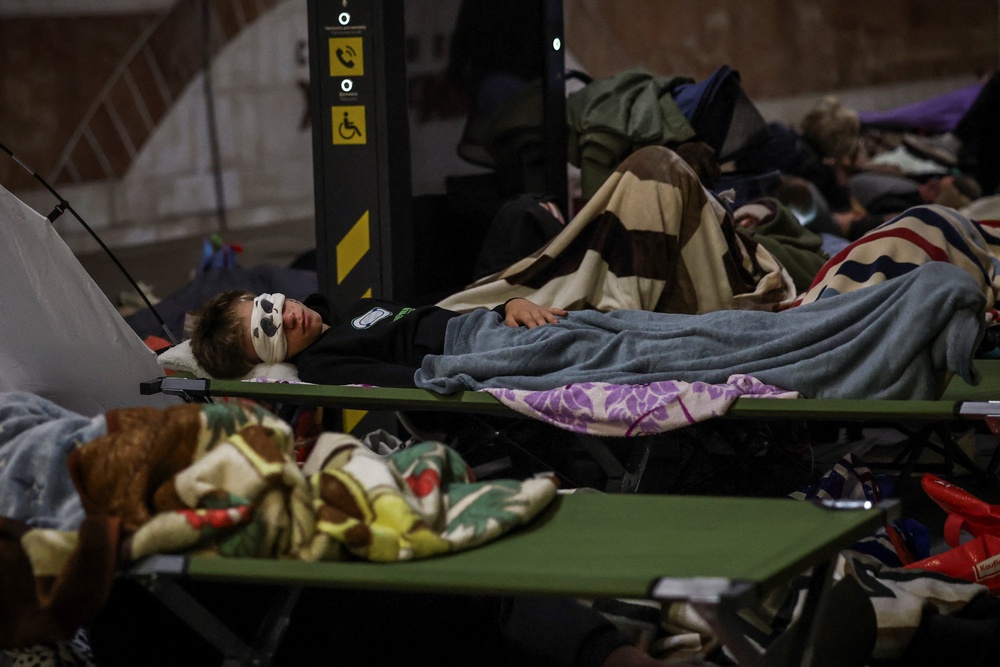 Residents sleep as they take shelter inside a metro station during a Russian missile strike, amid Russia's attack on Ukraine, in Kyiv (Reuters)