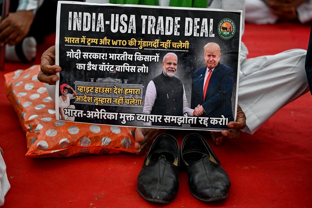 A farmer takes part in a protest demanding a legal guarantee of minimum support price for crops and the exclusion of agricultural imports from the India-US free trade agreement (AFP/Getty)