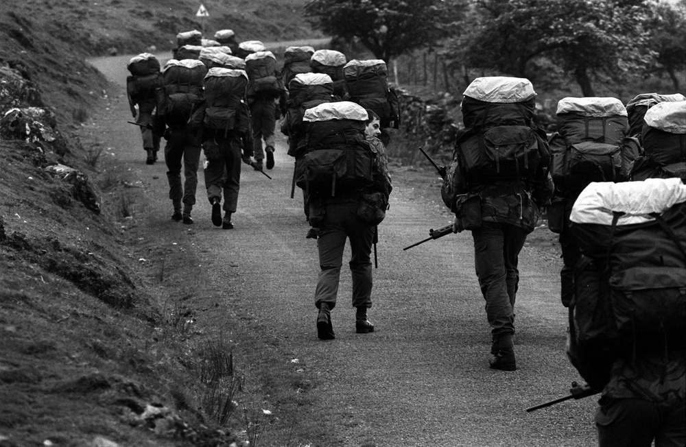 SAS recruits trek to the top of a mountain peak with 45lb backpacks on as part of an endurance exercise in the 1980s (PA)