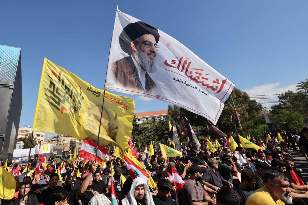 Supporters of Lebanese Shia movement Hezbollah hold up a flag bearing the image of slain leader Hassan Nasrallah during a ceremony held to mark the second anniversary of Nasrallah's killing in a strike by Israel, in Beirut's southern suburbs on September 27 (AFP/Getty)