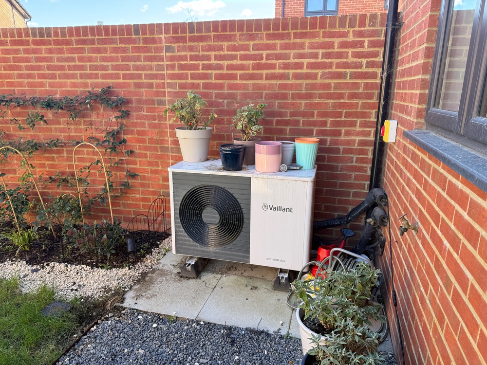 Our heat pump is installed in a corner of the garden. The front vents cannot be fully covered, but slatted wooden structures can be bought to partially enclose the unit and soften the industrial aesthetic, provided they don’t restrict airflow (Alistair Charlton/The Independent)