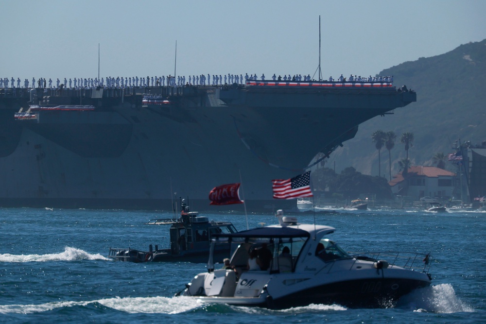 Crew members stand on the deck as the USS Abraham Lincoln Nimitz-class aircraft carrier approaches its homeport at Naval Air Station North Island on return from its historic 10-month deployment on October 8 (Getty Images)