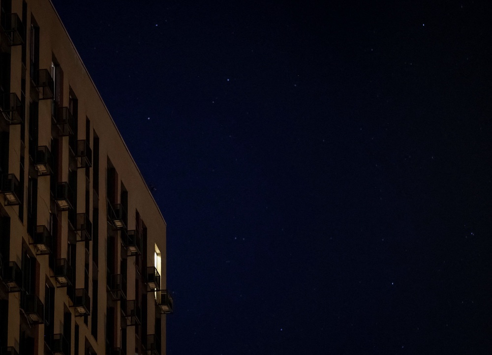 A window is illuminated in a residential building during a power blackout after critical civil infrastructure was hit by Russian missile and drone attacks (Reuters)