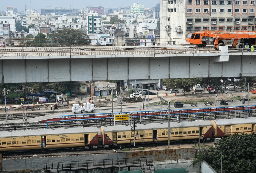 File. A passenger train remains halted at a railway station, beside the construction site of the bullet train project - Mumbai-Ahmedabad High Speed Rail corridor - in Vadodara on 4 February 2026 (AFP/Getty)