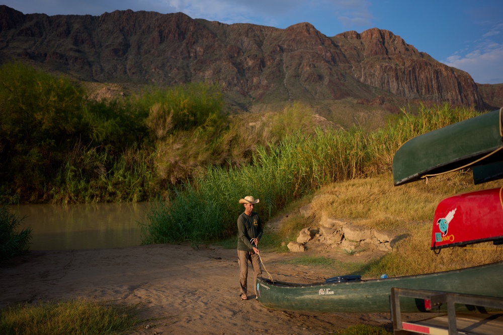 Charlie Angell unloads a canoe during a guiding trip on the Rio Grande river in Big Bend Ranch State Park, Thursday, Sept. 24, 2026, near Redford, Texas. (AP Photo/John Locher) (Copyright 2026 The Associated Press. All rights reserved.)