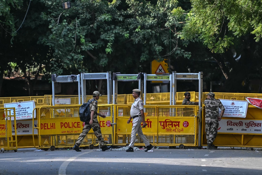Security personnel walk past barricades at Jantar Mantar in Delhi on 9 October 2026 (AFP/Getty)