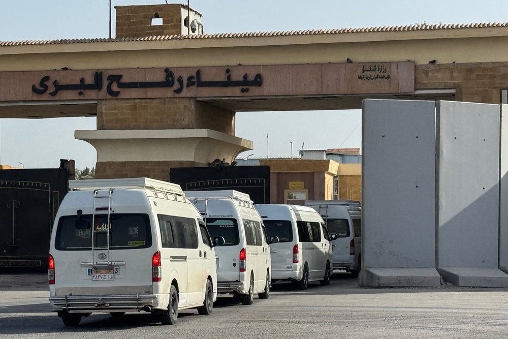 Minibuses carrying Palestinians wishing to return to the Gaza Strip line up on the Egyptian side of the Rafah border crossing on March 19, 2026. (AFP/Getty)