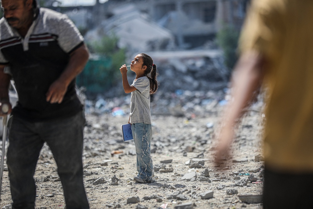 A child walks through a rubble-covered street as residents move among damaged buildings in the Al-Tuffah neighborhood of Gaza City, Gaza Strip on September 22, 2026. (AFP/Getty)