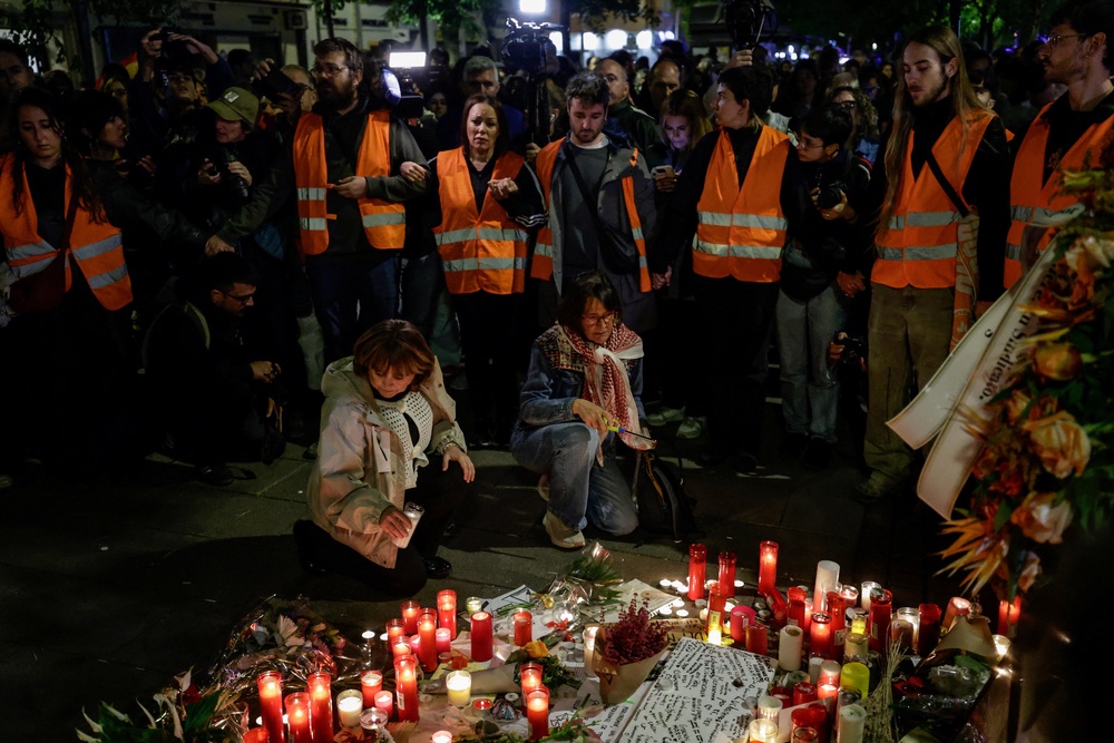 Protesters gather around a makeshift memorial outside the building where Maricarmen Abascal lived (Reuters)