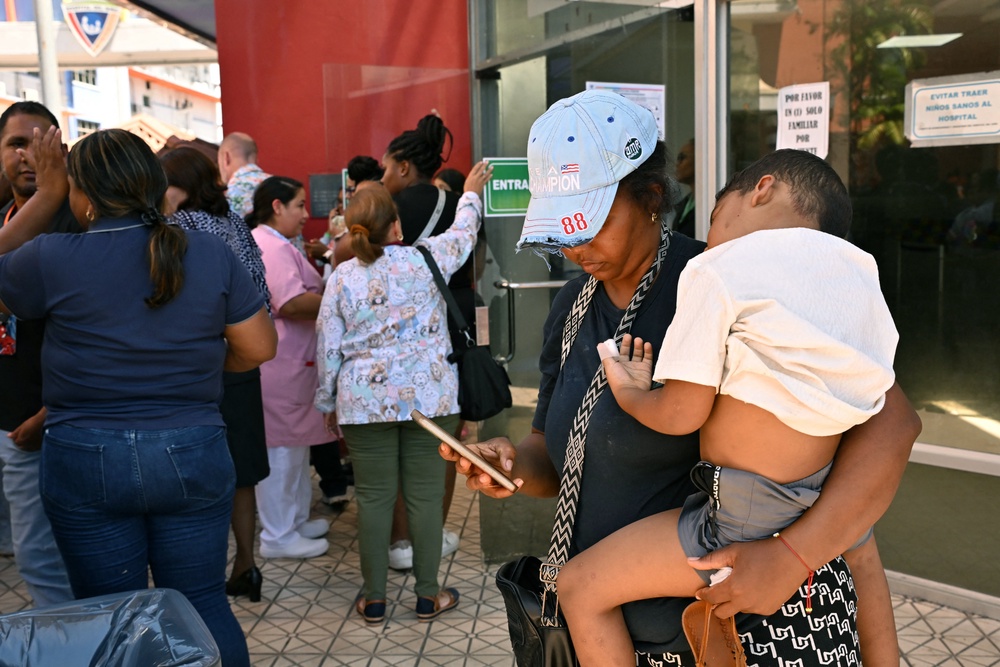 Visibly shaken residents waited in the streets for news of the impact (AFP/Getty)