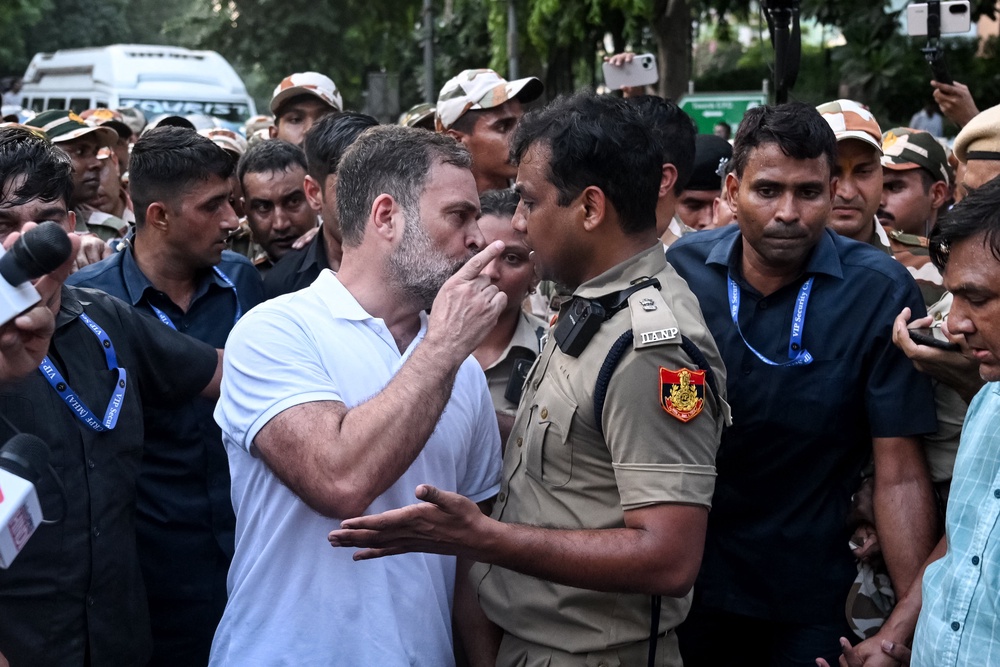 Rahul Gandhi scuffles with a policeman during a protest by the opposition in Delhi (AFP/Getty)