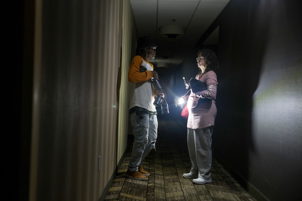 Kevin Hudgins helps guest Laura Gower after a power outage at the Residence Inn (Getty)