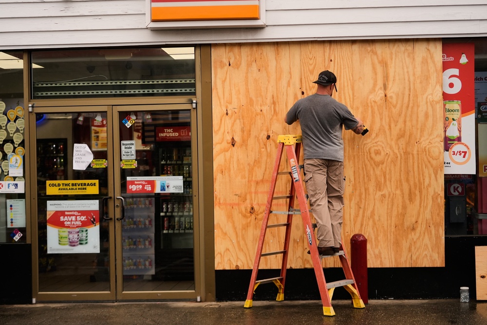Jason Coffey boards up a convenience store at a gas station as Hurricane Isaias approaches Pensacola Beach, Fla., Friday, Oct. 9, 2026 (AP Photo/Gerald Herbert)