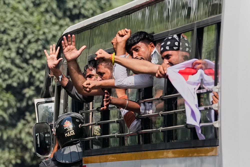 Detained protesters shout slogans during a demonstration demanding the resignation of chief election commissioner Gyanesh Kumar in Delhi (AP)